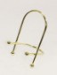 A brass easel in front of a beige background