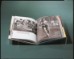 Book on clear acrylic mount in front of green-gray background