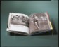Book on clear acrylic mount in front of green-gray background