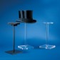 An assortment of helmet/hat stands, one of which is displaying a top hat