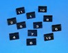 Black acrylic triangular blocks with white numbers in front of a light blue background