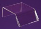 A clear acrylic display mount in front of a purple background