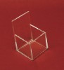 Clear acrylic box in front of red background
