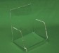 Clear acrylic display stand in front of green background