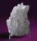 Crystal on acrylic mount in front of purple background